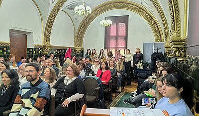 conference attendees listening to a talk in a lecture hall